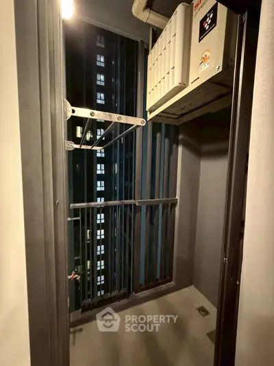 Compact balcony with urban view and air conditioning unit