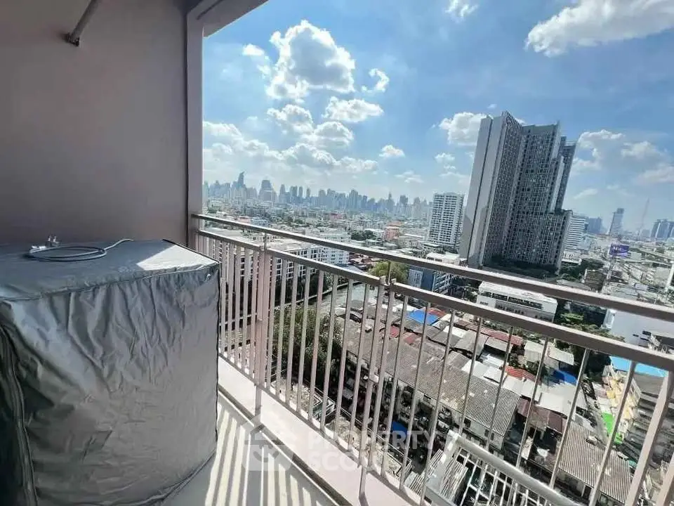 Stunning cityscape view from a high-rise balcony with clear blue skies.