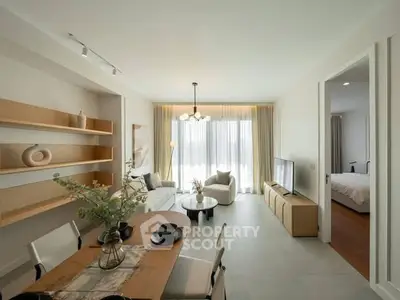 Modern open-plan living room with dining area and natural light