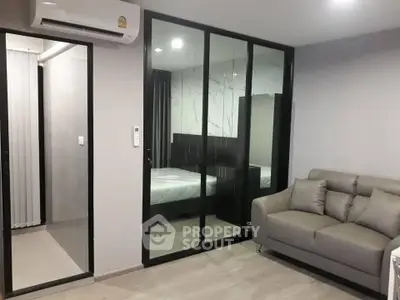 Modern living room with glass partition and cozy sofa in stylish apartment
