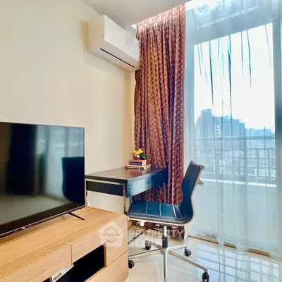 Modern study area with city view, featuring sleek desk, chair, and TV in a bright apartment.