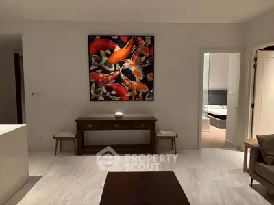 Modern living room with stylish decor and vibrant artwork, showcasing a cozy and inviting atmosphere.