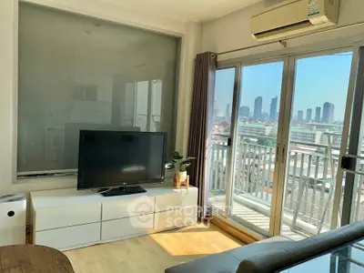 Modern living room with balcony and city view, featuring sleek furniture and abundant natural light.
