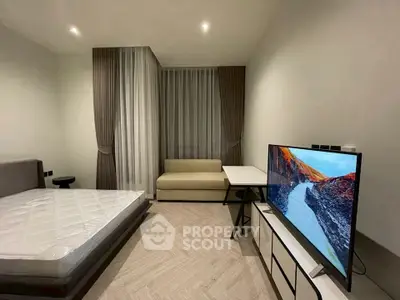 Modern bedroom with minimalist decor and large TV setup