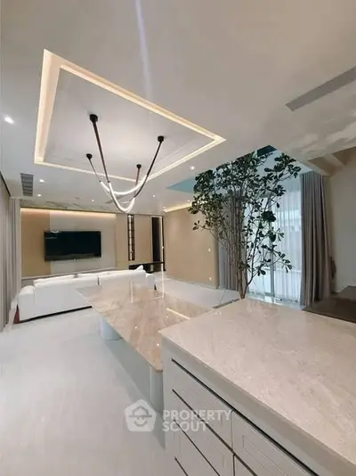 Luxurious modern living room with elegant ceiling design and spacious layout.