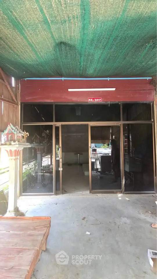 Charming storefront with glass doors and shaded entrance, ideal for small business or retail space.