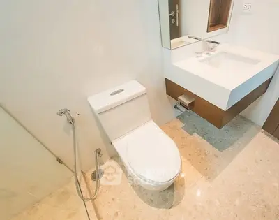 Modern bathroom with sleek fixtures and elegant marble flooring.