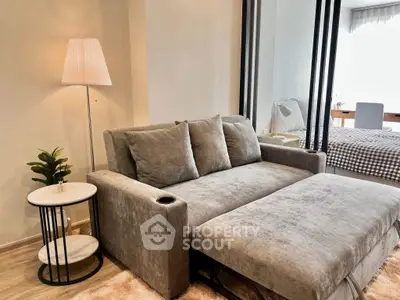 Modern living room with stylish gray sofa and elegant floor lamp