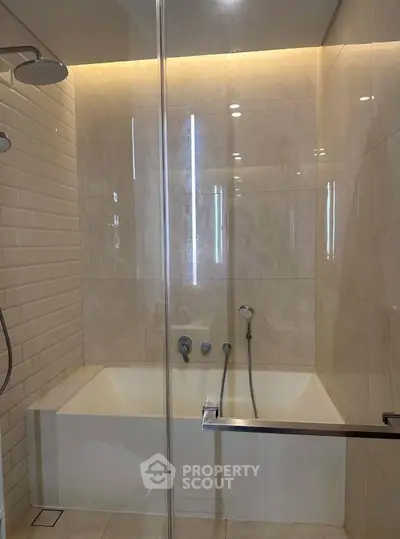 Modern bathroom with elegant bathtub and glass shower enclosure