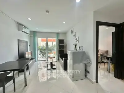 Modern living room with sleek furniture and balcony view in a stylish apartment.