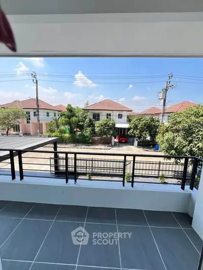 Spacious balcony with a serene neighborhood view, perfect for relaxation and enjoying the outdoors.