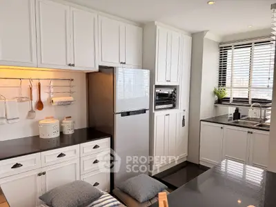 Modern kitchen with sleek black countertops and built-in appliances