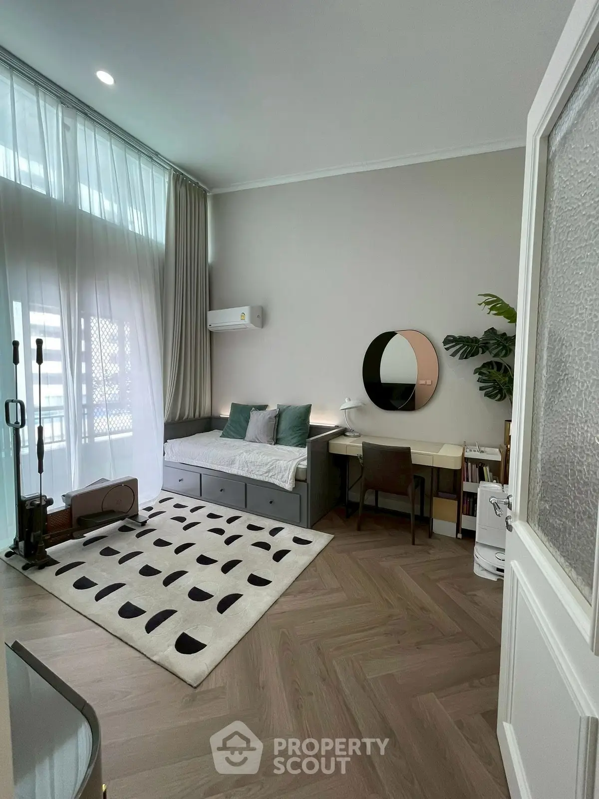 Chic study room with modern decor, large window, and stylish furniture in a contemporary apartment.