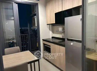 Modern kitchen with sleek cabinetry and city view from balcony
