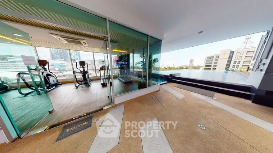 Modern gym with poolside view in luxury apartment complex