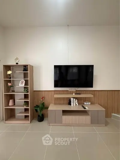 Modern living room with sleek TV setup and stylish shelving unit