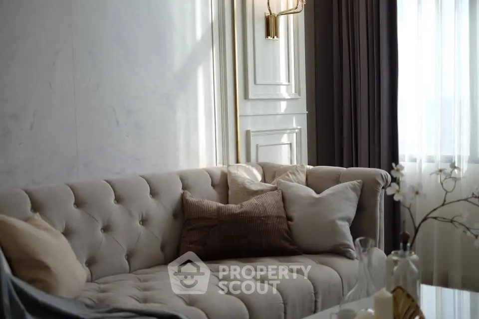Elegant living room with plush sofa and soft lighting, perfect for relaxation.