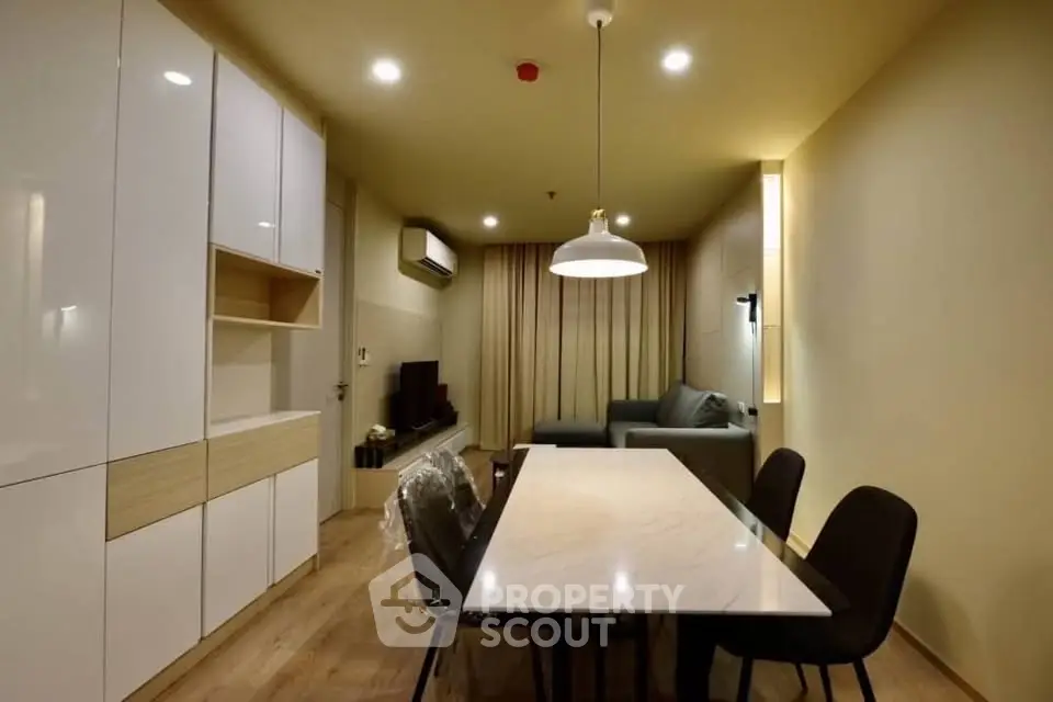 Modern living room with sleek furniture and ambient lighting in a cozy apartment.