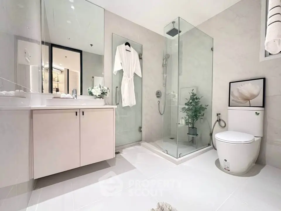 Luxurious modern bathroom with glass shower and elegant decor