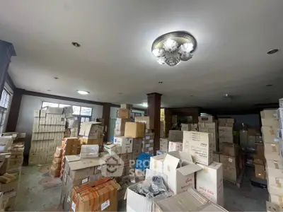 Spacious storage room filled with boxes, ideal for warehouse or commercial use.