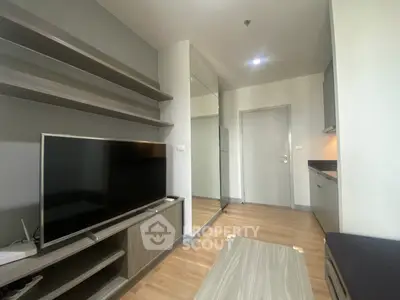 Modern living room with sleek TV unit and open kitchen layout