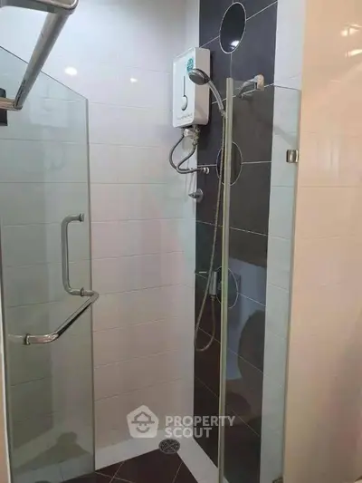Modern bathroom with glass shower enclosure and sleek fixtures
