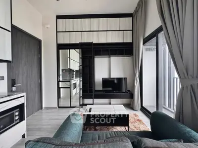 Modern living room with sleek furniture and large windows for natural light.