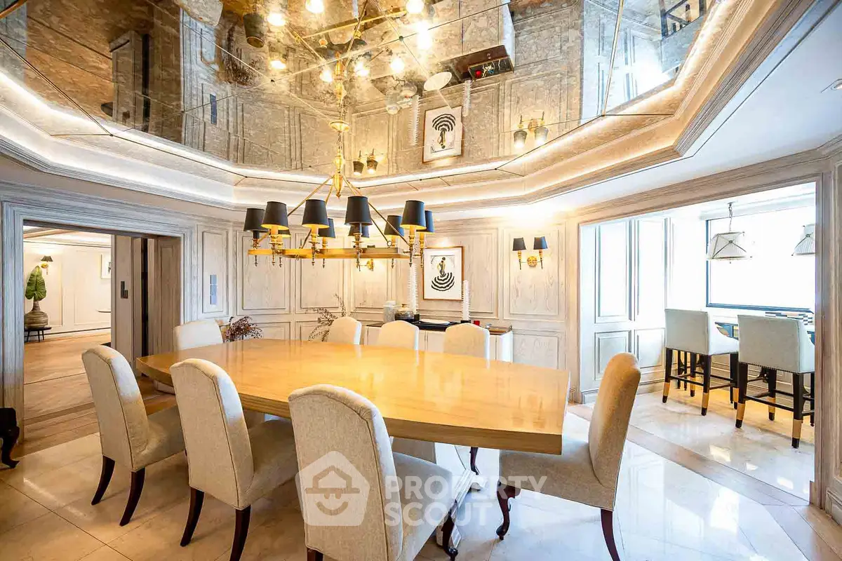 Luxurious dining room with elegant chandelier and mirrored ceiling in upscale property