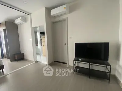 Modern living room with air conditioning and TV setup in a stylish apartment