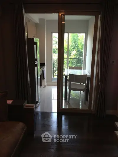 Charming apartment with a cozy dining area and lush garden view, perfect for intimate meals and relaxation.