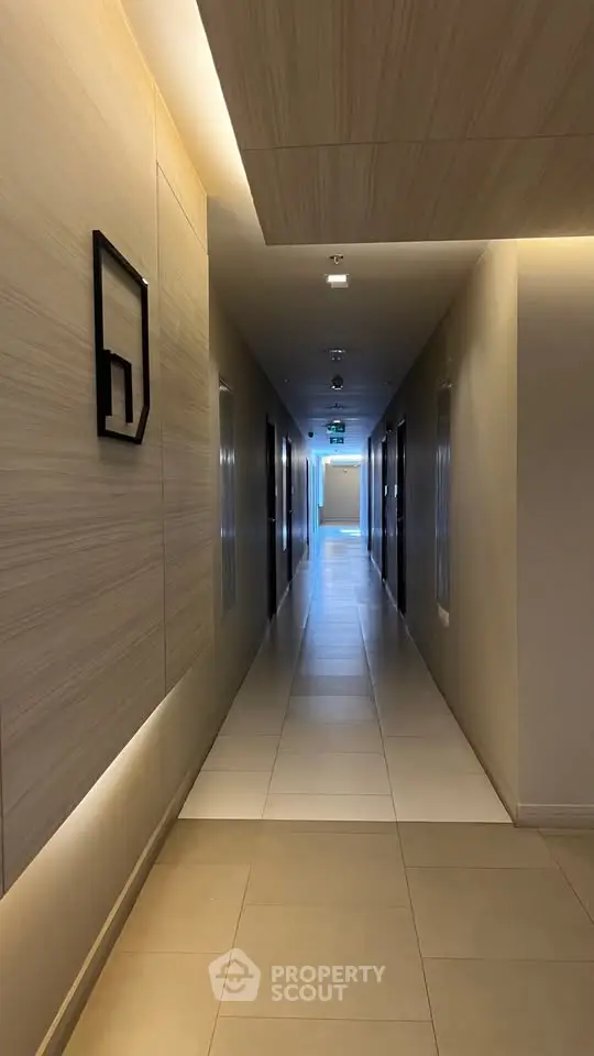 Modern corridor with sleek design and ambient lighting in a contemporary building.