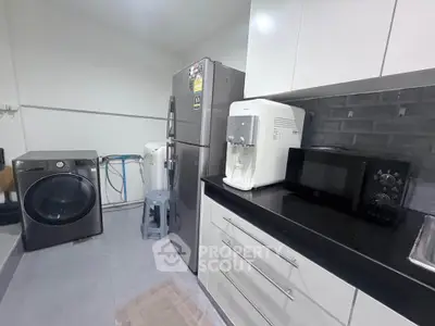 Modern kitchen with sleek appliances and ample storage space