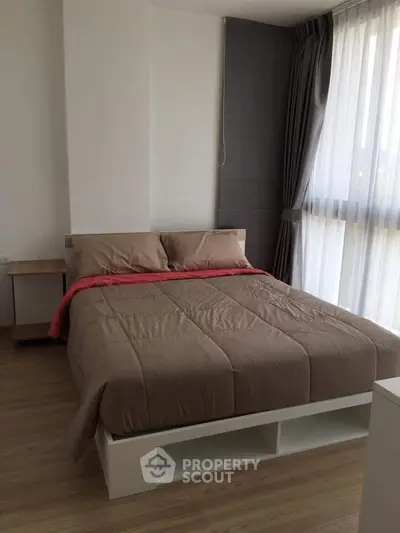 Modern bedroom with large window and stylish decor