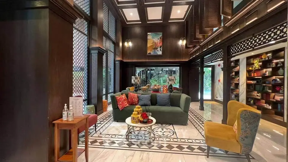 Luxurious living room with high ceilings and elegant decor in a sophisticated setting.