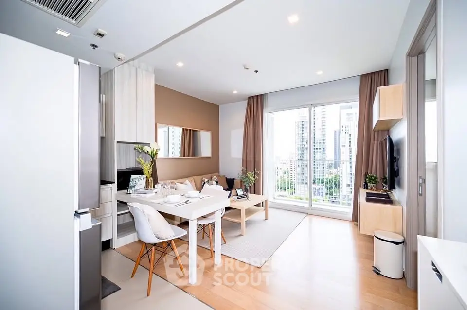 Modern open-plan living room with dining area and city view, featuring stylish decor and natural light.