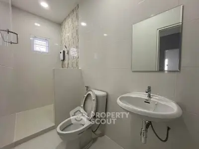 Modern bathroom with sleek fixtures and walk-in shower in a contemporary home.