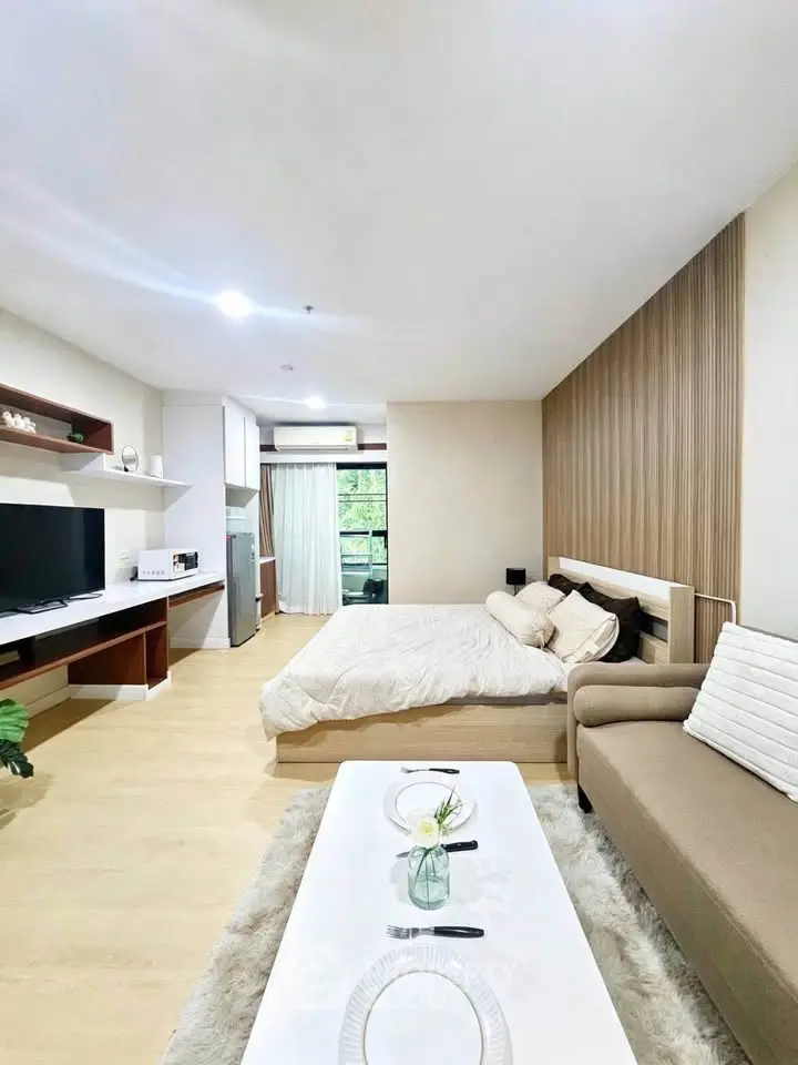 Modern studio apartment with cozy living area and stylish decor