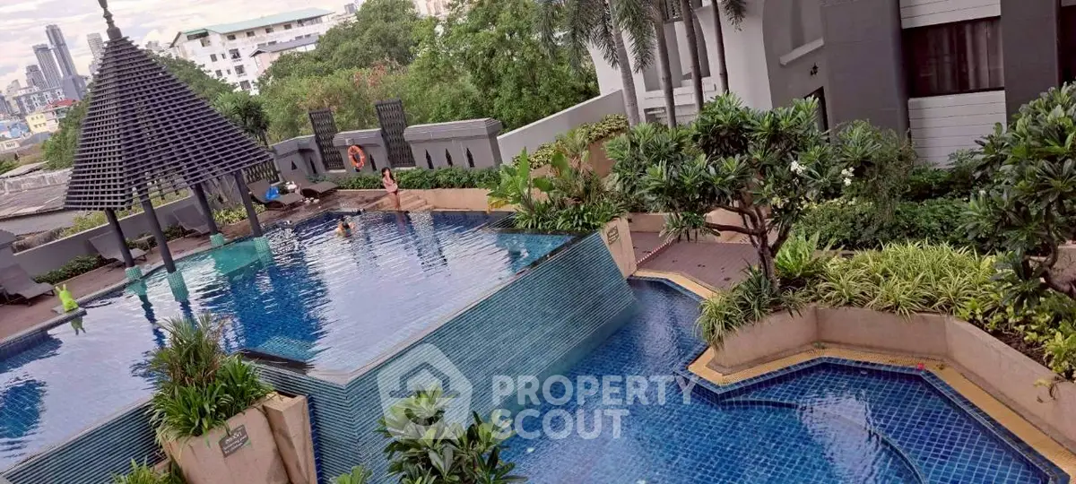 Luxurious rooftop pool with stunning city views and lush greenery, perfect for relaxation and leisure.