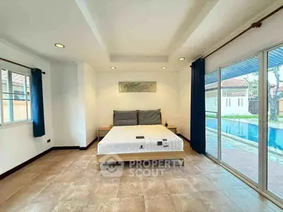 Spacious bedroom with pool view and modern decor