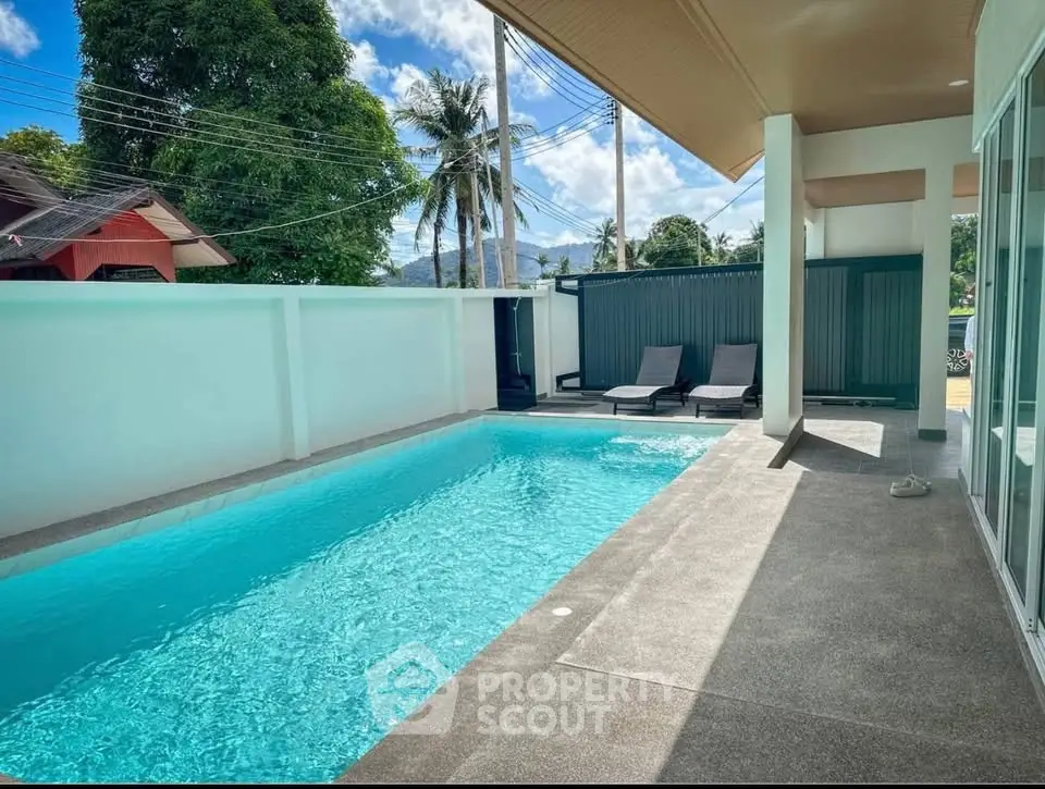 Luxurious private pool area with modern design and sun loungers, perfect for relaxation and leisure.