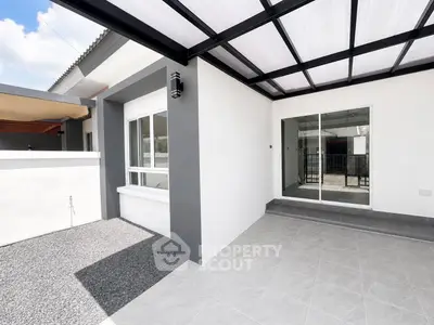Modern outdoor patio with sleek design and large windows in a contemporary home.