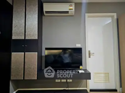 Modern living room with wall-mounted TV and air conditioning unit