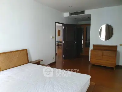 Spacious bedroom with wooden furniture and modern design