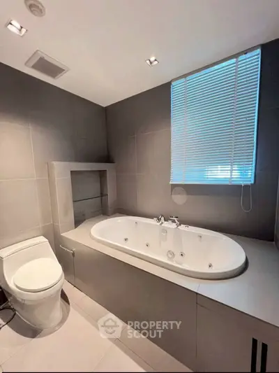 Modern bathroom with sleek bathtub and contemporary design.