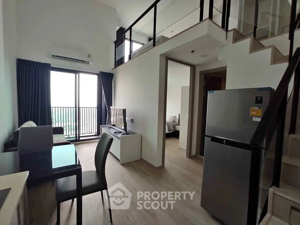 Modern loft apartment with open living area and balcony view