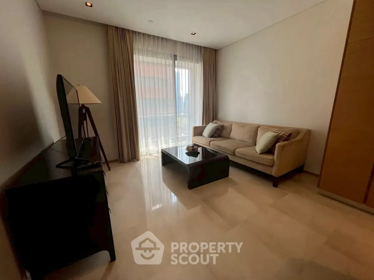 Elegant living room with modern sofa and large window offering natural light