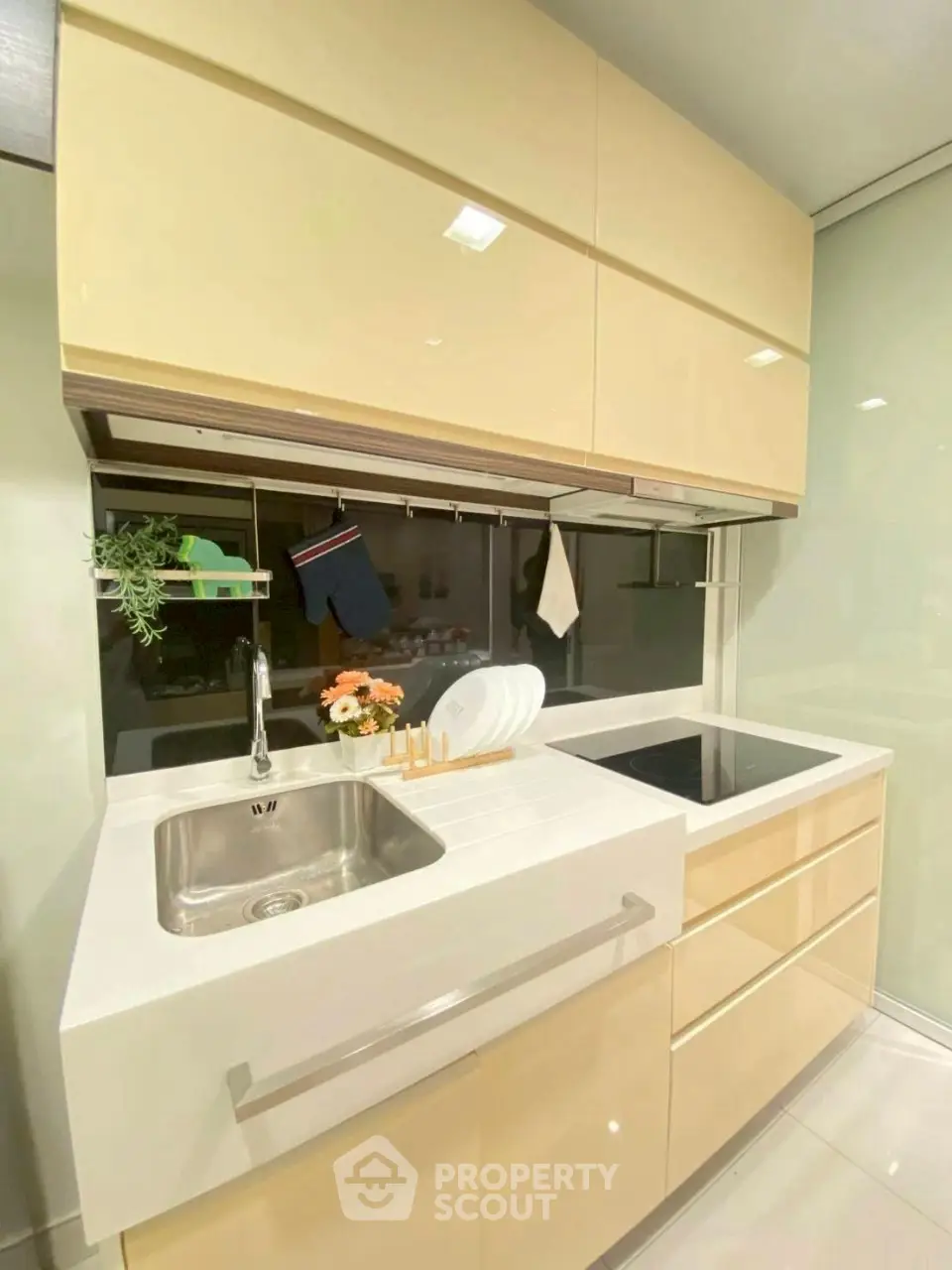 Modern compact kitchen with sleek cabinetry and built-in appliances