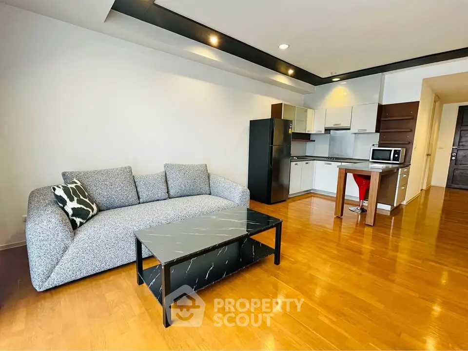 Modern open-layout living room with sleek kitchen and stylish furniture