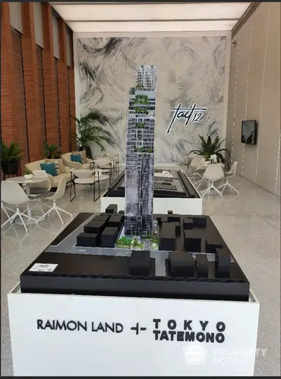 Modern real estate showroom with architectural model of luxury skyscraper and stylish interior design.