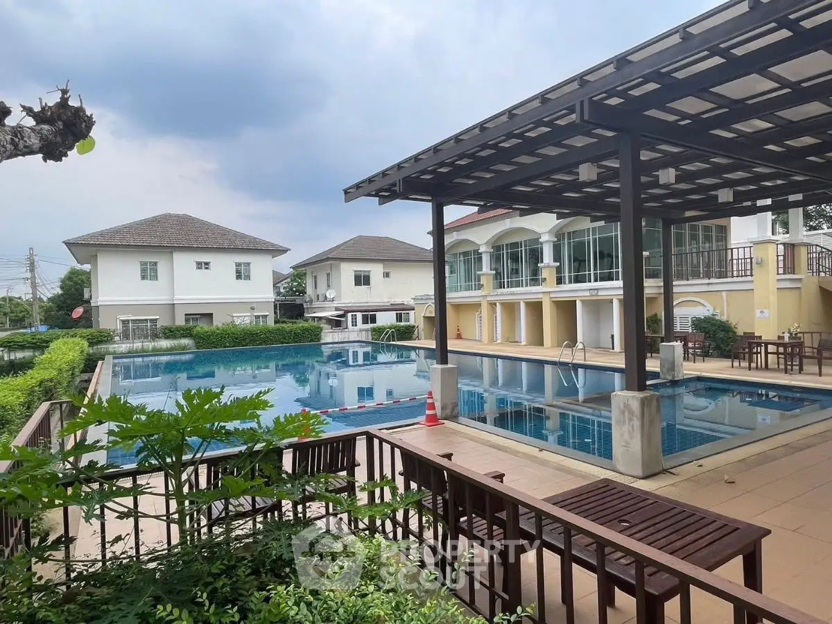 Luxurious residential complex with a stunning outdoor pool and elegant architecture.